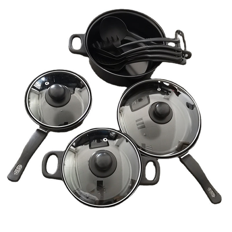 Set of black cookware with glass lids on a white background