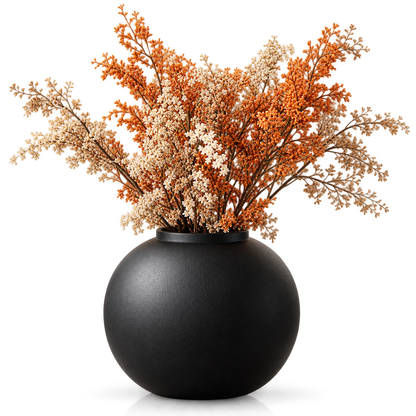 A matte black spherical vase filled with dried floral stems in orange, cream, and tan tones, photographed against a clean white background.